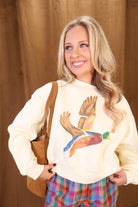 Cream cropped mallard graphic sweatshirt — close-up of crew neckline and duck graphic.