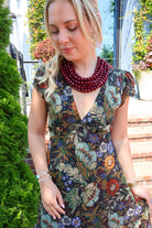 Bohemian floral maxi dress with a V-neck, flutter sleeves, and a tiered ruffle skirt