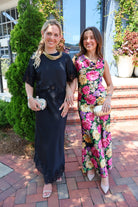 Black satin two-piece set with a lace-trim crop top and matching lace-trim skirt