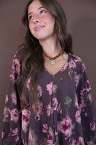 Brown Floral Tiered Babydoll Mini Dress — close-up of V-neckline and floral print.