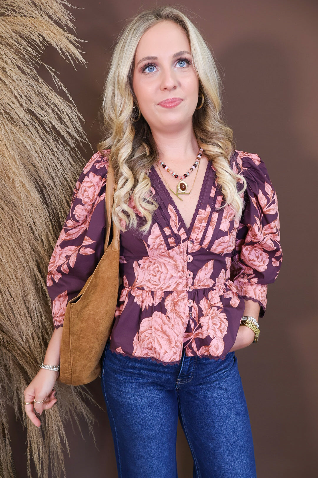 Model wearing the Wine Pink Floral V Neck Top from Moda Boutique