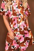 Model wearing the Brown & Pink Floral Puff Sleeve Dress from Moda Boutique