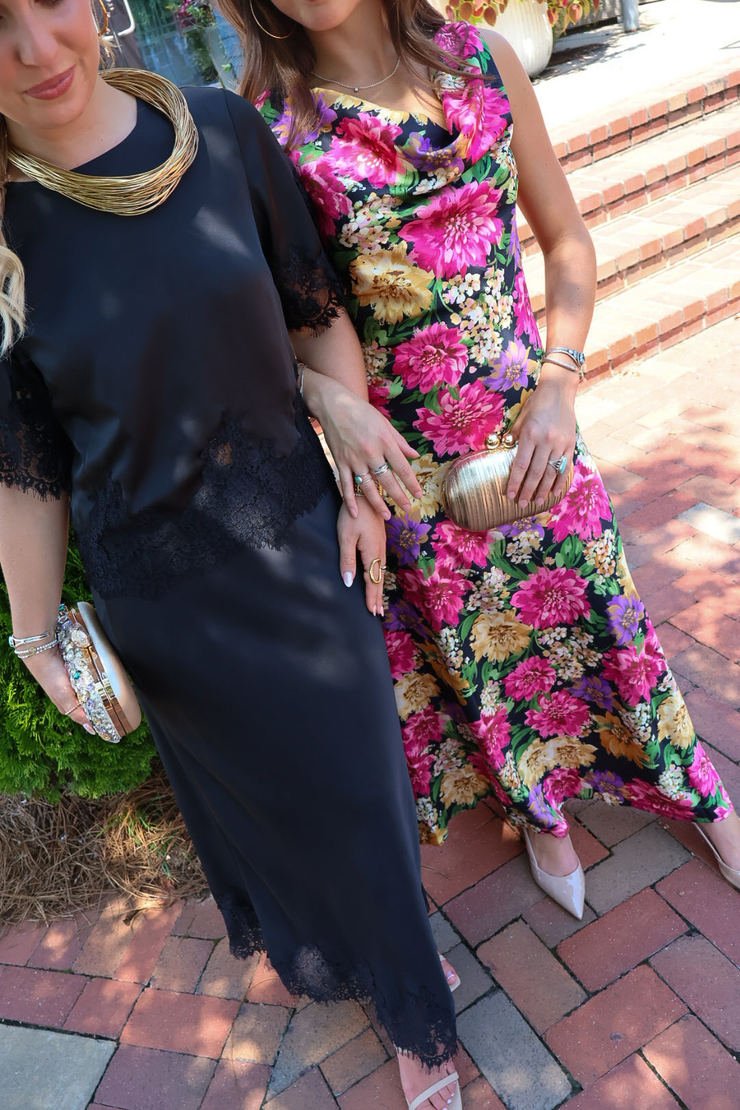 Black satin two-piece set with a lace-trim crop top and matching lace-trim skirt