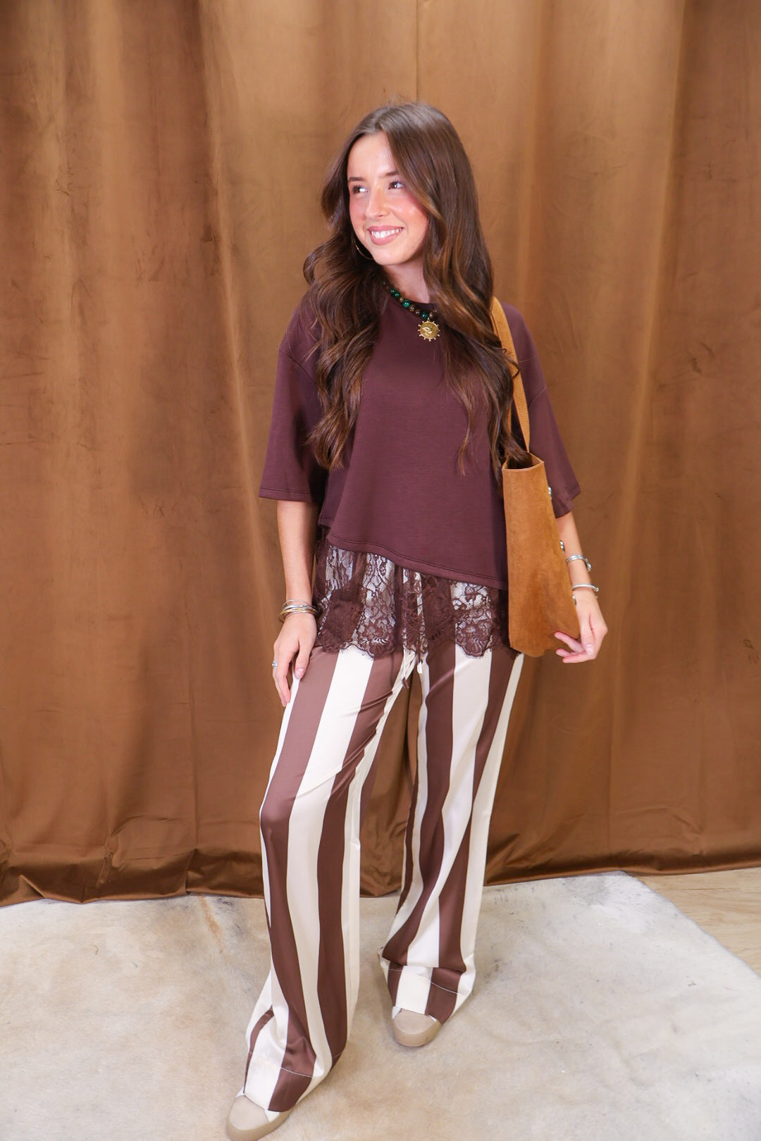Brown Tee With Asymmetrical Lace Hem — full outfit with a handbag.