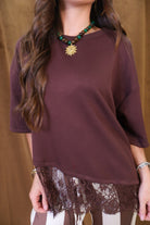 Brown Tee With Asymmetrical Lace Hem — close-up of asymmetrical lace hem.