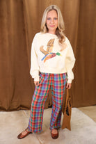 Cream cropped mallard graphic sweatshirt — full outfit with plaid pants and flats.