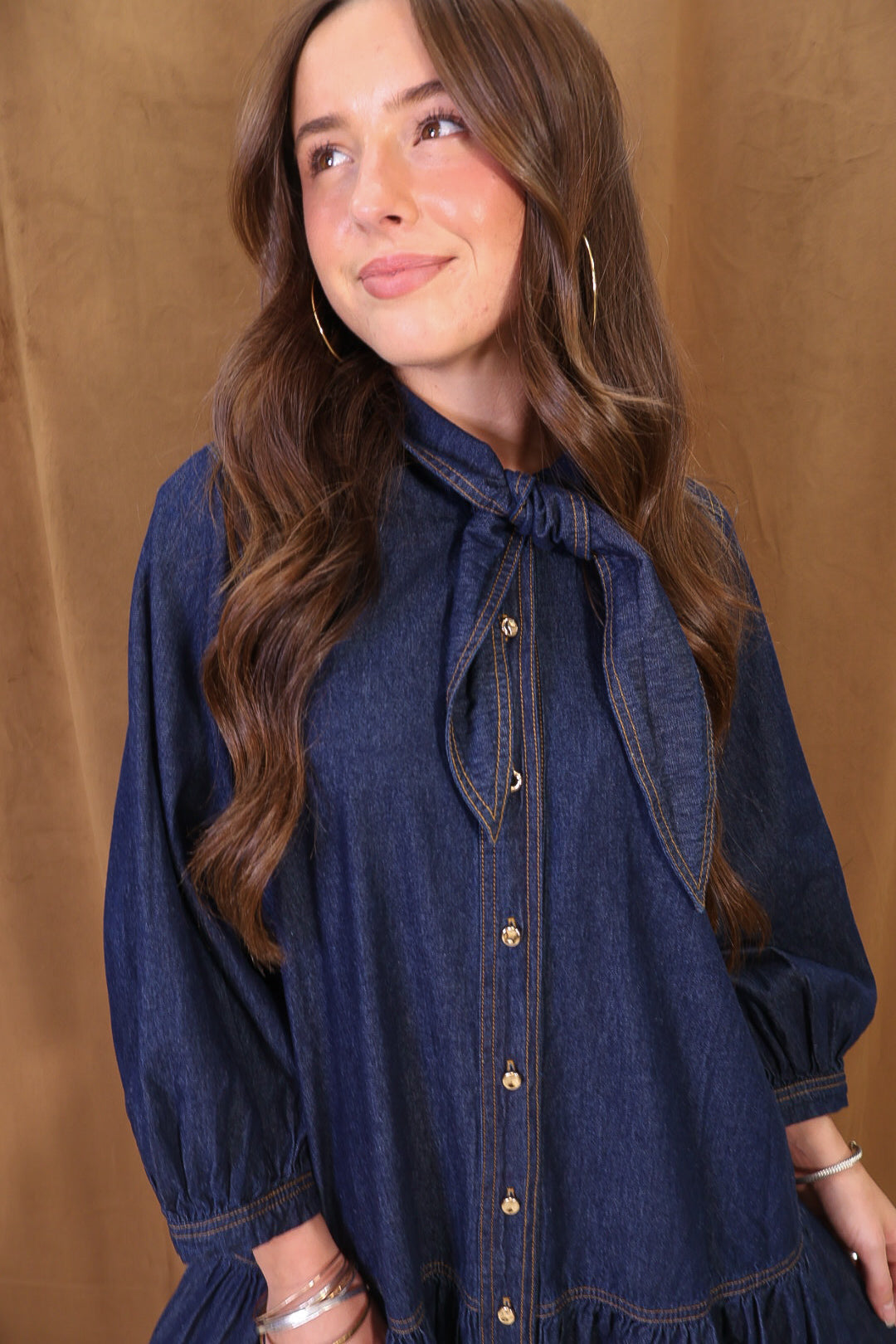 Dark Denim Tie-Neck Babydoll Dress — close-up of tie neckline and buttons.