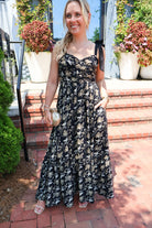 Black maxi dress with gold floral embroidery and ribbon shoulder ties