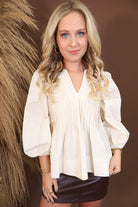 Model wearing the Cream Pintuck Quarter Sleeve Top from Moda Boutique