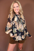 Black Floral Tie-Front Blouse — front view styled with olive shorts.