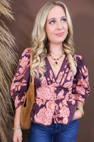 Model wearing the Wine Pink Floral V Neck Top from Moda Boutique