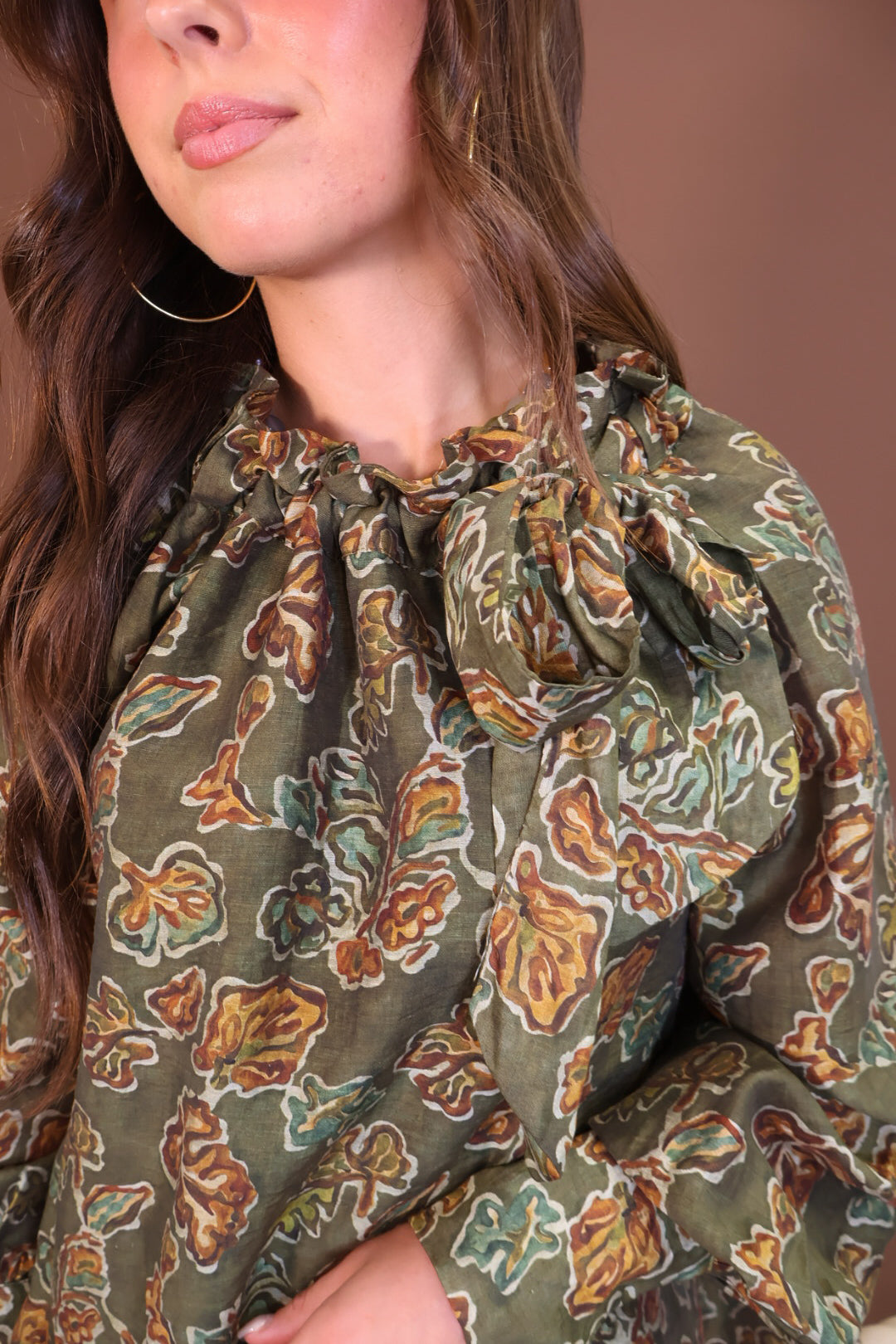 Olive Floral Tie-Neck Blouse — close-up of tie neckline and floral print.