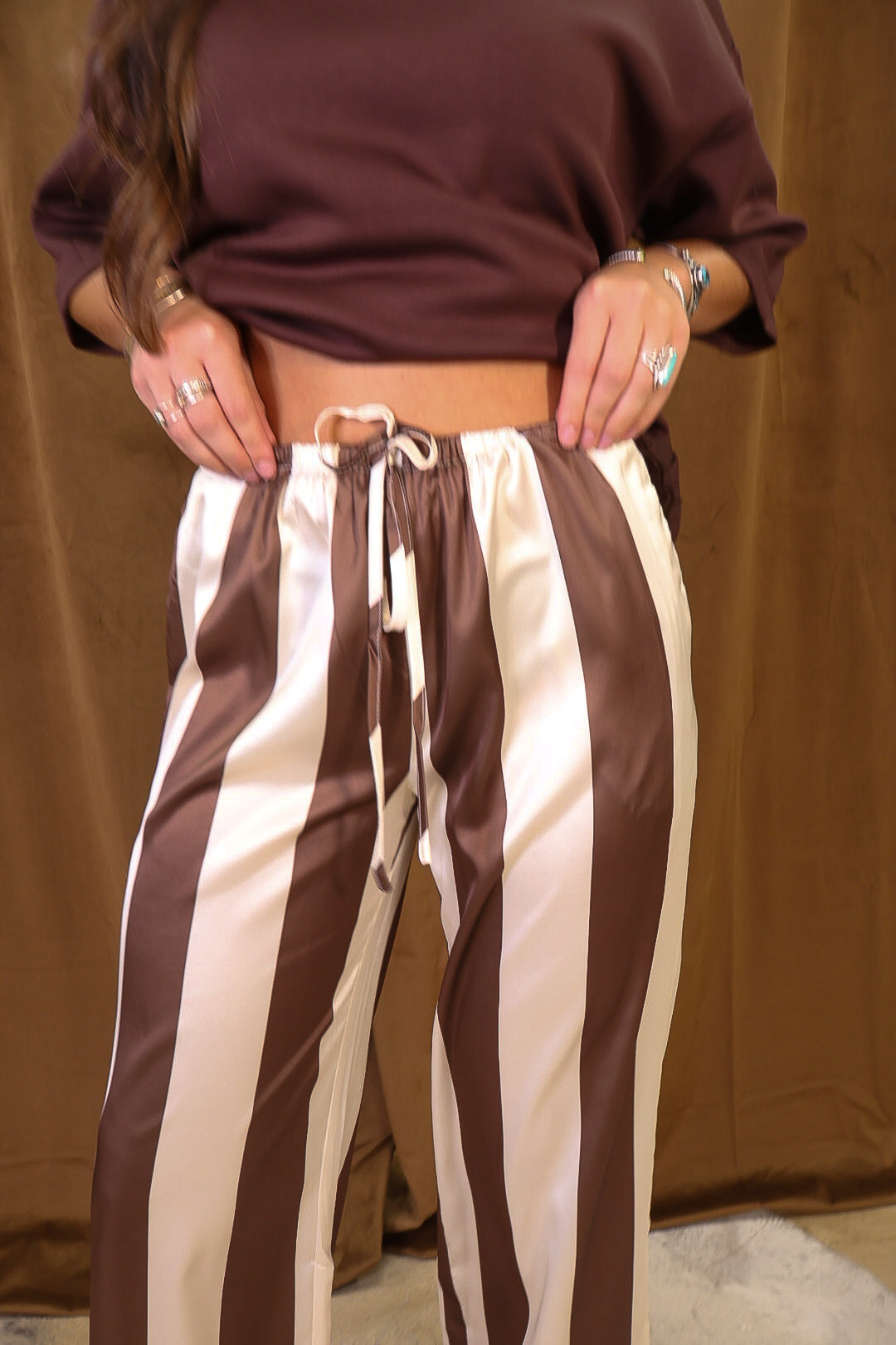 Brown And Cream Satin Striped Wide Leg Pants — close-up of drawstring waist.