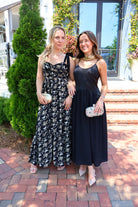 Black maxi dress with gold floral embroidery and ribbon shoulder ties