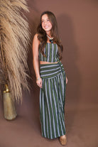 Model wearing the Olive Striped Crop Top and Midi Skirt Set from Moda Boutique
