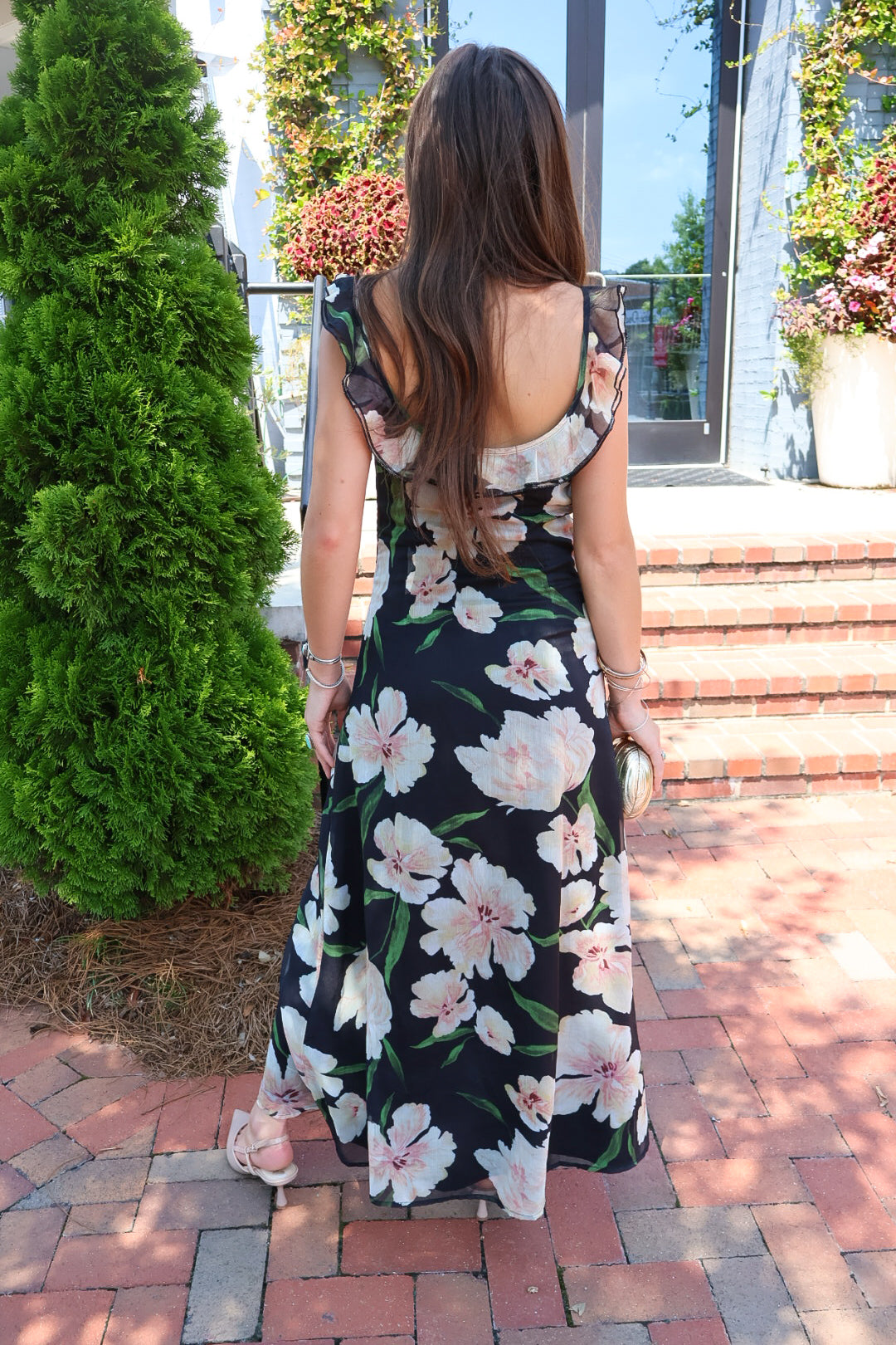 Black floral maxi dress with blush and cream blooms, ruffle straps, and a self-tie bust