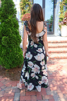 Black floral maxi dress with blush and cream blooms, ruffle straps, and a self-tie bust