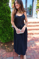 Black satin cami maxi dress with a scooped neck and flowy gathered skirt