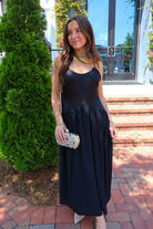 Black satin cami maxi dress with a scooped neck and flowy gathered skirt