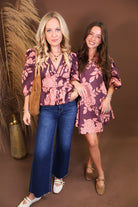 Model wearing the Wine Pink Floral V Neck Top from Moda Boutique