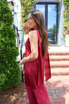 Burgundy satin slip maxi dress with adjustable straps and a detachable neck scarf