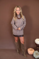 Mocha Mock Neck Tunic Sweater — full outfit with a dark mini skirt and tall boots.