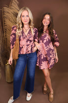 Model wearing the Wine Pink Floral Mini Dress from Moda Boutique