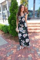 Black floral maxi dress with blush and cream blooms, ruffle straps, and a self-tie bust
