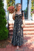 Black maxi dress with gold floral embroidery and ribbon shoulder ties
