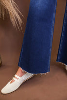 Raw hem detail on Lovervet dark-wash cropped jeans