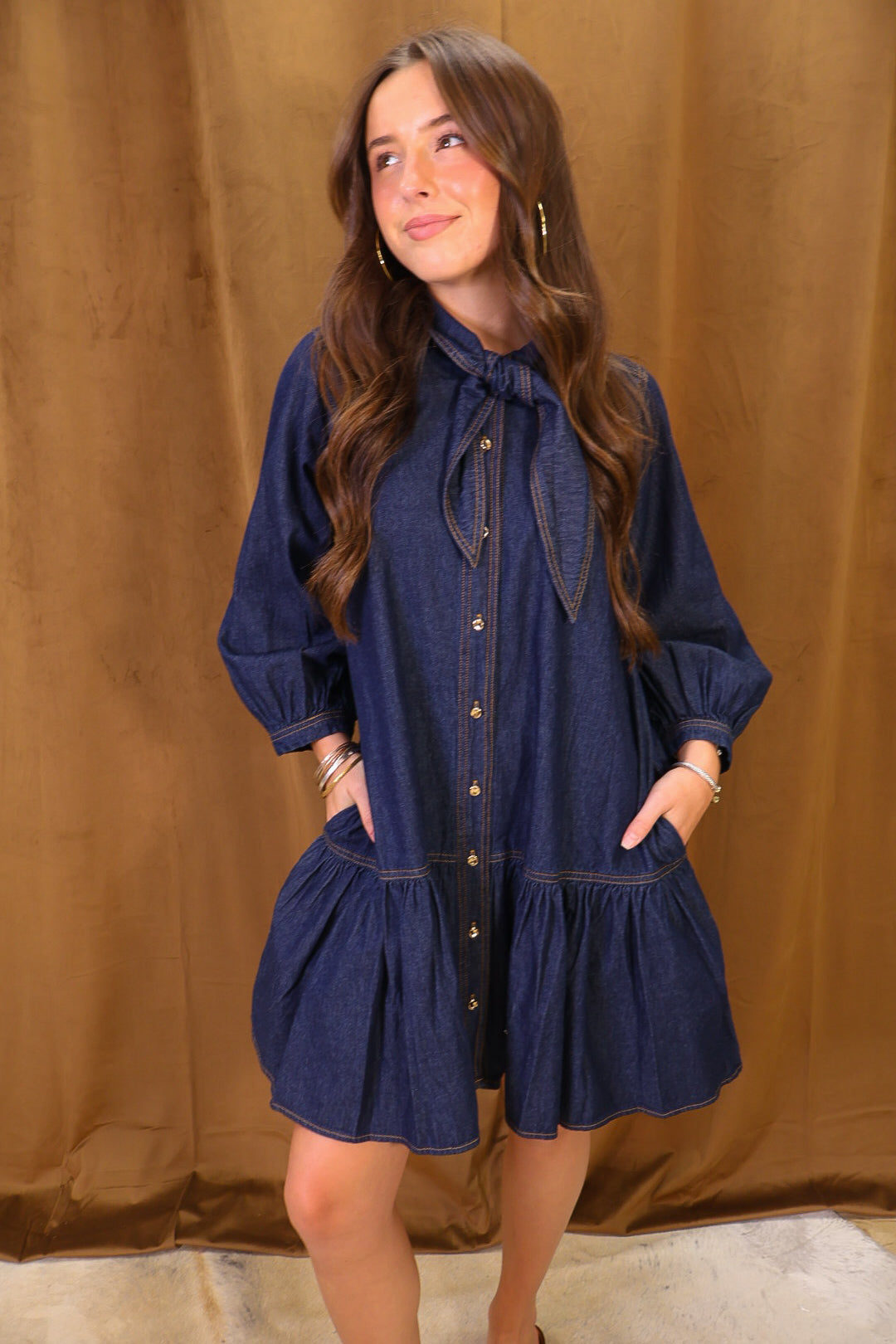 Dark Denim Tie-Neck Babydoll Dress — front view showing pockets.