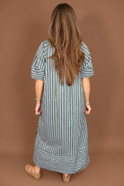 Model wearing the Blue Green Striped Midi Dress from Moda Boutique