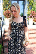 Black maxi dress with gold floral embroidery and ribbon shoulder ties