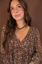 Brown Floral Long Sleeve Midi Dress — close-up of V-neckline and floral print.