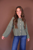 Olive Pom Pom Knit Cardigan — front view with sleeves extended.