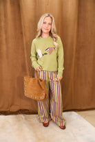 Green Flying Mallards Sweater — full outfit with striped pants.
