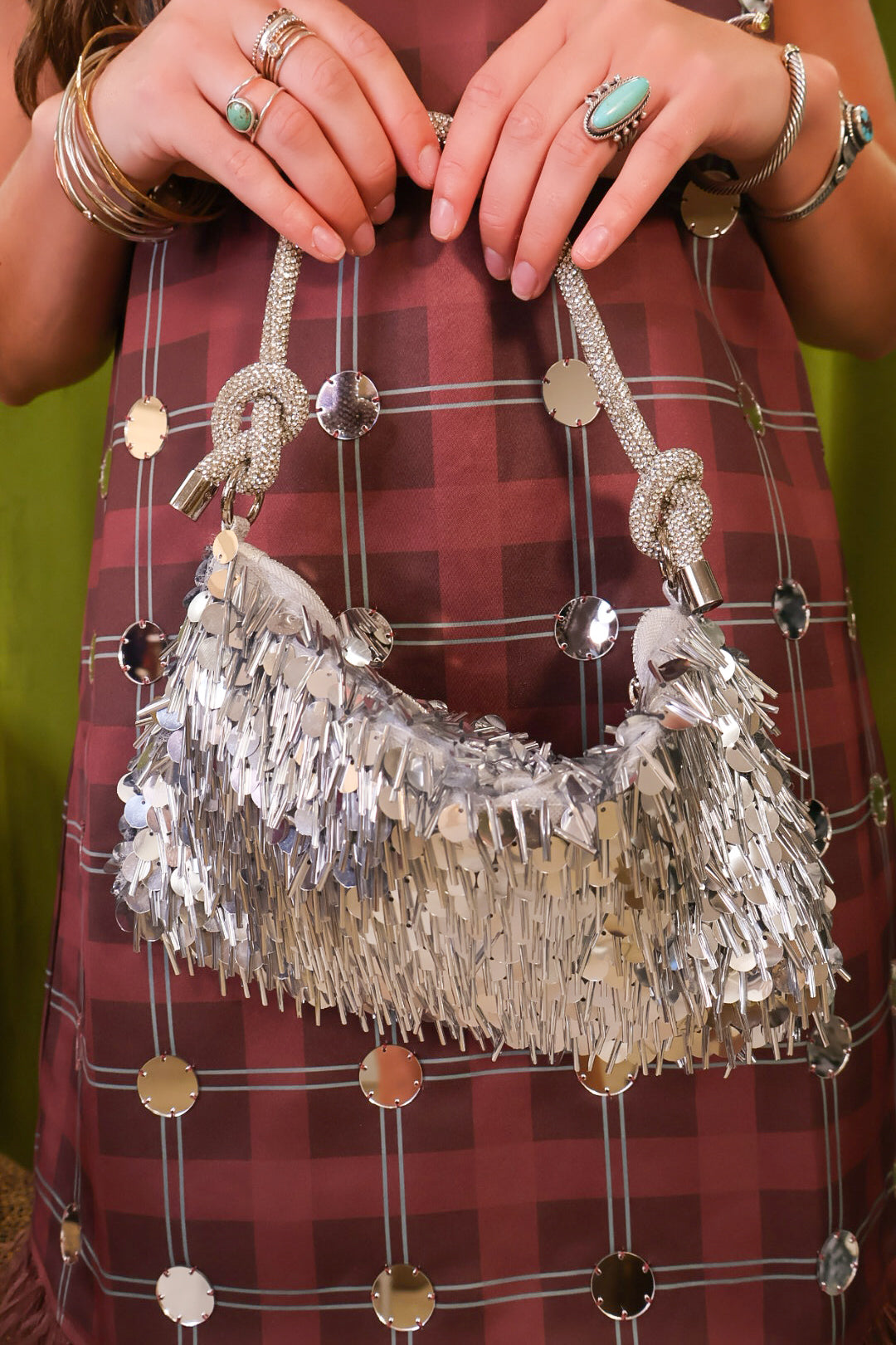 Silver sequin fringe shoulder bag with sparkling knotted handle.
