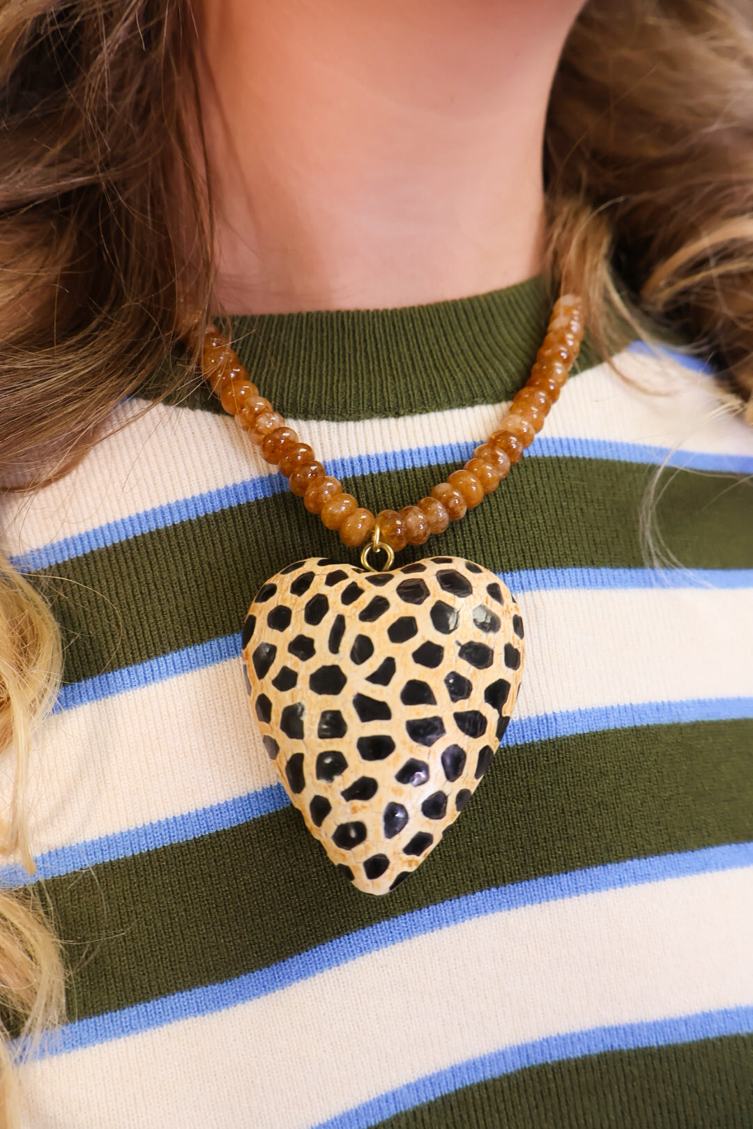 Spotted wooden heart pendant on amber beaded necklace